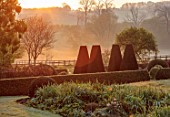 PETTIFERS, OXFORDSHIRE: DAWN, SUNRTISE, LIGHT ON THE YEW TOPIARY ANDBOX PARTERRE, MAY
