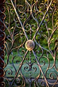 WEST DEAN GARDENS, WEST SUSSEX: ORNATE METAL GATE IN THE ORCHARD, GATES, FROSTY, MORNING, MAY