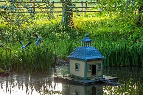 PRIORS_MARSTON_WARWICKSHIRE_POOL_POND_AND_DUCK_HOUSE_SPRING_MAY_SCULPTED_RABBITS_BY_WILLIAM_YEOWARD_
