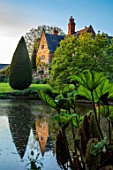 COTON MANOR, NORTHAMPTONSHIRE: THE MANOR HOUSE SEEN FROM THE POOL, POND, WATER, LAKE, SPRING, MAT, GUNNERA MANICATA, REFLECTED, REFLECTIONS