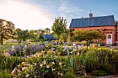 MORTON HALL, WORCESTERSHIRE: WEST GARDEN, EVENING, HOUSE, BORDERS, BEDS, IRISES, COUNTRY, GARDEN, ENGLISH, CLASSIC
