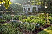 VEN HOUSE, SOMERSET: THE WALLED GARDEN, JUNE, SUMMER, VEGETABLE GARDEN, POOL HOUSE, ONIONS, NO DIG BEDS, SUNDIAL