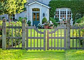 WESTBROOK HOUSE, SOMERSET: OAK GATE, FENCE, PYRUS NIVALIS, SNOW PEAR TREES, COUNTRY, GARDEN, SUMMER, GRASS PATH