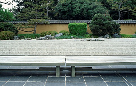 SIMPLE_WOODEN_BENCHES_AND_RAKED_GRAVEL_IN_THE_JAPANESE_ZEN_GARDEN_AT_THE_HUNTINGTON_BOTANICAL_GARDEN