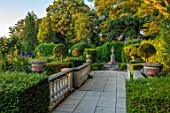 THE LASKETT GARDENS, HEREFORDSHIRE. DESIGNER ROY STRONG - PAVING, BALUSTRADES, STATUES, CLIPPED TOPIARY, SHAKESPEARE MONUMENT, SUMMER, JULY, SUNRISE, DAWN