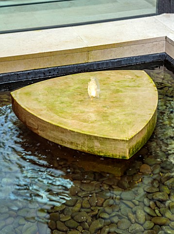 FULHAM_GARDEN_LONDON_DESIGNER_HARRY_HOLDING_STONE_WATER_FEATURE_SPOUT_SPOUTING_POOL_RILL_PEBBLES