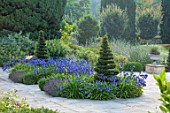PRIVATE GARDEN, GLOUCESTERSHIRE - DESIGNER ANGEL COLLINS: TERRACE WITH AGAPANTHUS NAVY BLUE, PERENNIALS, BULBS, SUMMER, AUGUST