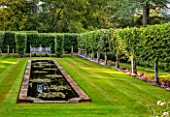 ROCKCLIFFE, GLOUCESTERSHIRE: PLEACHED LIMES, GRASS, LAWN, FORMAL, RECTANGULAR, POOL, POND, RILL, HEDGES, HEDGING, STONE BENCH, SEATING, SEATS