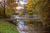 SPETCHLEY PARK GARDENS, WORCESTERSHIRE: WHITE METAL BRIDGE OVER THE CANAL, AUTUMN, OCTOBER, FALL, FOLIAGE, TREES, PARKLAND, MALVERN HILLS IN BACKGROUND