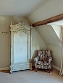 THE HYDE, HEREFORDSHIRE: CHAIR AND WARDROBE IN BEDROOM