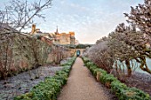 ROUSHAM, OXFORDSHIRE: JANUARY, FROST, FROSTY, WINTER, PATH THROUGH THE WALLED GARDEN, BORDERS, GATE, YEW HEDGES, HEDGING
