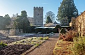 ROUSHAM, OXFORDSHIRE: JANUARY, WINTER, THE WALLED VEGETABLE GARDEN, POTAGER, YEW HEDGES, HEDGING, CHURCH