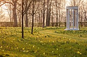 MORTON HALL, WORCESTERSHIRE: THE MEADOW, PARK, PARKLAND, SPRING, APRIL, WOODLAND, DAFFODILS, NARCISSUS, SUNRISE, SNAKES HEAD FRITILLARY, FRITILLARIA MELEAGRIS