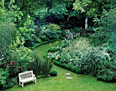 WHITE WOODEN BENCH ON LAWN WITH ROSES & PHORMIUM TENAX. BOX EDGED SILVER BORDER & PATH LEADS TO STATUE.DES:OLIVIA CLARKE
