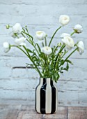 SMITH & MUNSON, LINCOLNSHIRE: BLACK AND WHITE VASE WITH WHITE RANUNCULUS