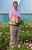 SMITH & MUNSON, LINCOLNSHIRE: ED MUNSON HOLDING RANUNCULUS IN A GREENHOUSE