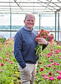 SMITH & MUNSON, LINCOLNSHIRE: STEPHEN MUNSON HOLDING RANUNCULUS IN A GREENHOUSE