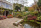 PATTHANA GARDEN, IRELAND: MAY, SPRING, SUNKEN PATIO, TULIPS IN CONTAINERS, STEPS UP TO LAWN, BLOSSOM, HOUSE, POOL, WATER, POND