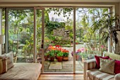 PATTHANA GARDEN, IRELAND: MAY, SPRING, VIEW ONTO PATIO, TULIPS IN CONTAINERS, INSIDE OUT