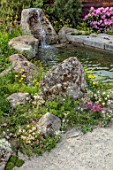 CHELSEA 2022: A SWISS SANCTUARY BY LILLY GOMM: RHODODENDRONS, GRAVEL PATHS, ROCKS, WATERFALL, POOL, POND