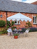ASHBROOK HOUSE, NORTHAMPTONSHIRE: SUMMER, PARASOL, UMBRELLA BY TITANIA, TABLE, CHAIRS, ENTERTAINING, COURTYARD