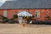 ASHBROOK HOUSE, NORTHAMPTONSHIRE: SUMMER, TABLE, CHAIRS, PARASOL, UMBRELLA BY TITANIA, COURTYARD