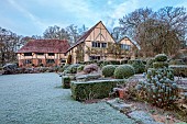LONG BARN GARDENS, KENT: FROST, WINTER, LAWN, HEDGES, HEDGING, BORDERS, CLIPPED TOPIARY YEW, EUPHORBIA