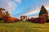 GOLDSBOROUGH HALL, YORKSHIRE: WINTER, THE HALL, LAWN, BEECH HEDGES, HEDGING, BORDERS