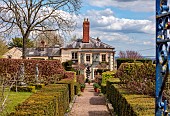 THE LASKETT, HEREFORDSHIRE: APRIL, VIEW TO THE HOUSE FROM THE COLONNADE, PATH, HEDGES, HEDGING