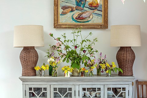 DRESSER_DECORATED_BY_ANNETTE_WARREN_NATURAL_FORAGED_FLOWERS_BLOOMS_OF_BULBS_APRIL_COWSLIPS_PINK_BLUE