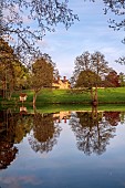FOSCOTE MANOR, BUCKINGHAMSHIRE: APRIL, SPRING, LAKE AND VIEW TO MANOR HOUSE
