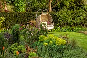 DESIGNER JAMES SCOTT, THE GARDEN COMPANY: SMALL, TOWN, GARDEN, SEATING, SEAT, SWING SEAT, LAWN, BORDERS, MAY, EUPHORBIA, HEDGES, HEDGING