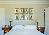 PRIVATE GARDEN, DEDHAM VALE, SUFFOLK: MASTER BEDROOM , WALLS PAINTED IN AMMONITE BY FARROW & BALL, VICTORIAN TINSEL PRINTS