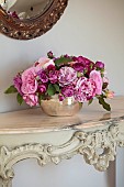PRIVATE GARDEN, DEDHAM VALE, SUFFOLK: ROSES FROM THE GARDEN ARRANGED ON A HALF CONSOLE FROM THE BOULE, GILT MIRROR