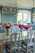 PRIVATE GARDEN, DEDHAM VALE, SUFFOLK: KITCHEN, TABLE, REPRODUCTION OF A FRENCH MONASTERY TABLE, PINK PEONIES FROM THE GARDEN