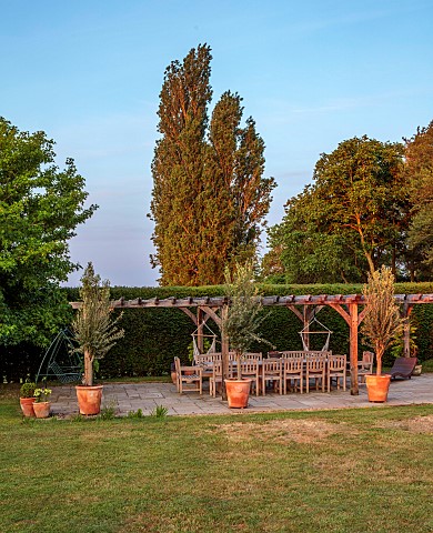 PRIVATE_GARDEN_DEDHAM_VALE_SUFFOLK_LAWN_PERGOLA_COVERED_SEATING_DINING_AREA_TABLE_CHAIRS_HEDGES_HEDG