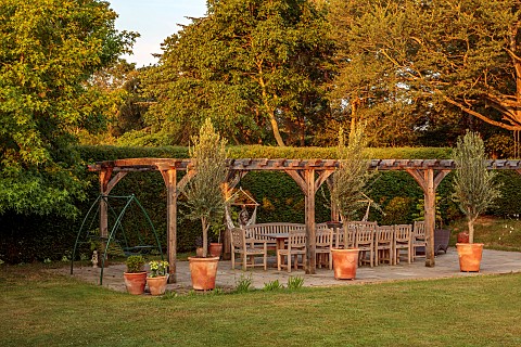 PRIVATE_GARDEN_DEDHAM_VALE_SUFFOLK_LAWN_PERGOLA_COVERED_SEATING_DINING_AREA_TABLE_CHAIRS_HEDGES_HEDG