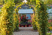 MORTON HALL GARDENS, WORCESTERSHIRE: JULY, KICHEN GARDENS, POTAGER, VEGETABLE, ARCH, CONTAINERS WITH CANNAS