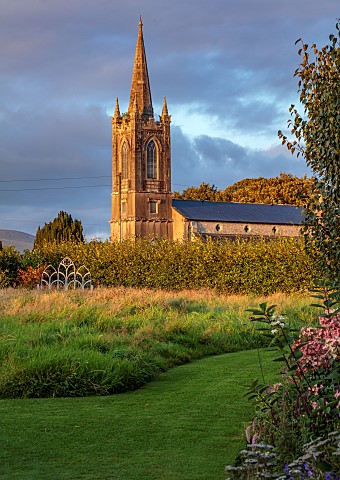 PATTHANA_GARDEN_IRELAND_VIEW_TO_CHURCH_WILDFLOWER_MEADOW_GRASS_PATH_SEAT