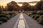 GRANTLEY HALL, YORKSHIRE: LIGHTING, DAWN, GRAVEL GARDEN, PATINATED STEEL AND COLOURED STAINLESS STEEL GLAZED CUPOLA SEAT AT END OF RILL, BORDERS, SEPTEMBER