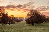 COTTESBROOKE HALL AND GARDENS, NORTHAMPTONSHIRE: VIEW FROM SOUTH TERRACE, SUNRISE, MARCH, SPRING, BORROWED LANDSCAPE