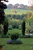 FASTIGIATE YEWS: GOTHIC ARCH DIVIDES CULTIVATED AND WILD GARDEN.THE WHITE HOUSE/ELISABETH WOODHOUSE