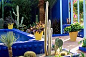 COURTYARD SURROUNDED BY CACTI  AND YELLOW TERRACOTTA POTS IN THE MOROCCAN STYLE YVES ST. LAURENT GARDEN DESIGNED BY MADISON COX. CHELSEA 97