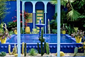 COBALT BLUE FOUNTAIN  CACTI  AND YELLOW TERRACOTTA POTS IN THE MOROCCAN STYLE YVES ST. LAURENT GARDEN DESIGNED BY MADISON COX. CHELSEA 97