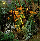 COPPER TUBES OF LIGHT BY GARDEN & SECURITY LIGHTING EMERGE BETWEEN ACHILLEA AND ORNAMENTAL GRASSES IN THE NATURAL AND ORIENTAL WATER GARDENS  HAMPTON COURT 97
