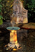 CERAMIC FOUNTAIN AND THRONE BY EMMA LUSH LIT UP AT NIGHT