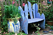 A PLACE TO SIT: BLUE PAINTED WOODEN  BENCH WITH CERAMIC POT PLANTED WITH PINK SNAPDRAGONS.  DESIGN BY KEEYLA MEADOWS SAN FRANCISCO