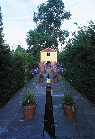 THE_TOWER_SEEN_FROM_THE_RILL_WITH_AGAPANTHUS_AFRICANUS_IN_A_POT_ARROW_COTTAGE__HEREFORDSHIRE