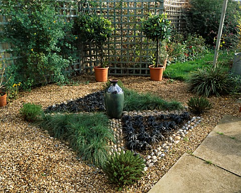 KNOT_GARDEN_WITH_GRAVEL__PEBBLES__BLACK_OPHIOPOGON_GRASS__FESTUCA_GLAUCA_AND_A_GREEN_GLAZED_POT_IN_T