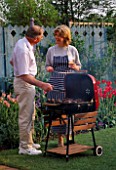 GRAHAM NICHOLS AND JANE NICHOLS AT THE BARBECUE IN THE NICHOLS GARDEN  READING